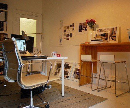 A desk with a chair and a laptop on it